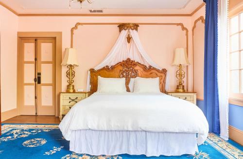 a bedroom with a large white bed with a canopy at Luxe Homestay in Hollywood - by The Grove & Walk of Fame in Los Angeles