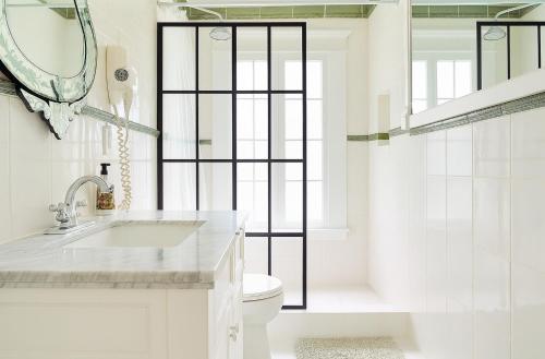 a white bathroom with a sink and a toilet at Luxe Homestay in Hollywood - by The Grove & Walk of Fame in Los Angeles