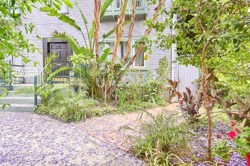 a garden in front of a house with a black door at Luxe Homestay in Hollywood - by The Grove & Walk of Fame in Los Angeles