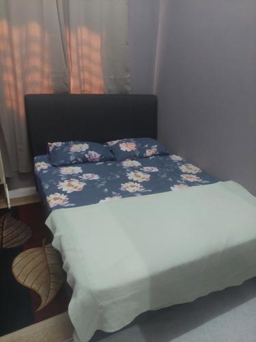 a bed with two pillows on it in a bedroom at Sumud Bonda Homestay in Kuala Kerai