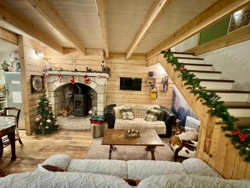 a living room filled with furniture and a fireplace at Agréable petite maison rustique in Saint-Geniès-de-Varensal