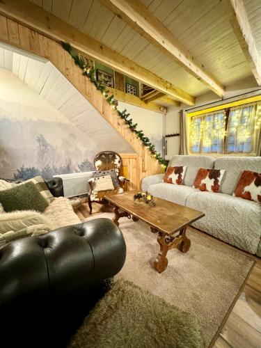 a living room with a couch and a table at Agréable petite maison rustique in Saint-Geniès-de-Varensal