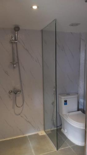 a bathroom with a shower and a toilet at Hidden Valley GLAMPING in Fujairah