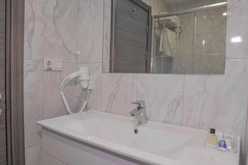a bathroom with a sink and a mirror at Sakarya Hotel in Sakarya