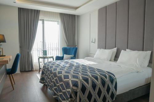a hotel room with a bed and a desk and a window at Sakarya Hotel in Sakarya