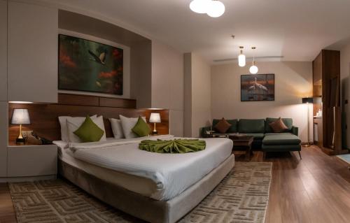 a hotel room with a large bed and a couch at Hyksos Hotel in Erbil