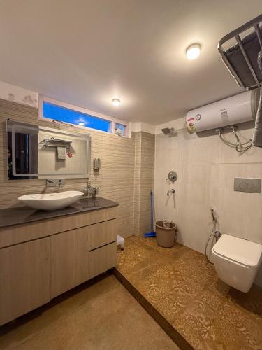 a bathroom with a sink and a toilet at Saffron 2 Bedroom Duplex Villa in Mukteshwar