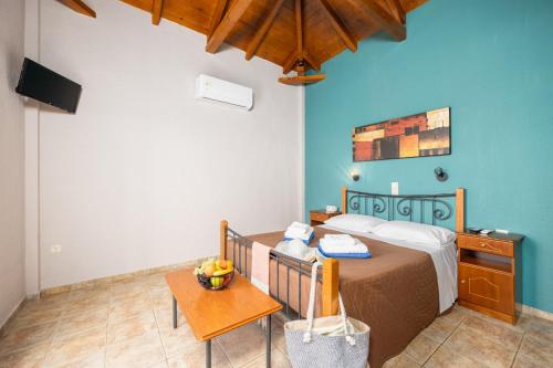 a small bedroom with a bed and a table at Panorama II Villas in Lévktron