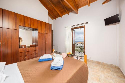 a bedroom with a bed and a large window at Panorama II Villas in Lévktron