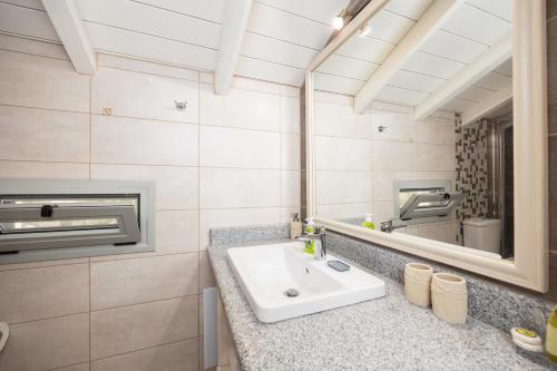 a bathroom with a sink and a mirror at Villa Stephania in Gaios