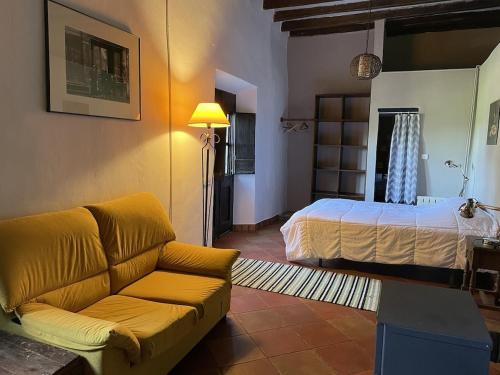 a living room with a bed and a couch at Mas Costa in Sant Ferriol