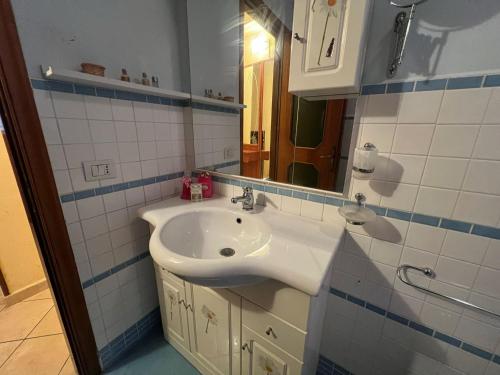 a bathroom with a white sink and a mirror at Cassiopea in Isnello
