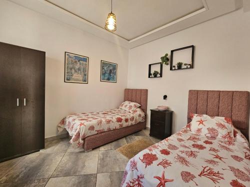 a bedroom with two beds and a bedskirts at Corazón Urbano in Martil