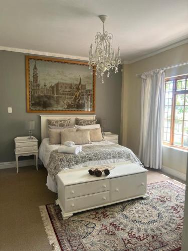 a bedroom with a bed with a cat laying on it at Boschberg Cottage in Somerset East