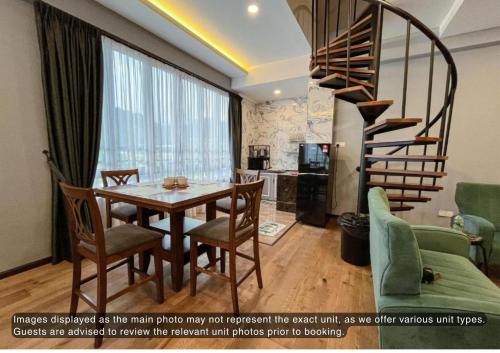 a dining room with a table and a spiral staircase at Hotel Lavie at Centrum in Brinchang