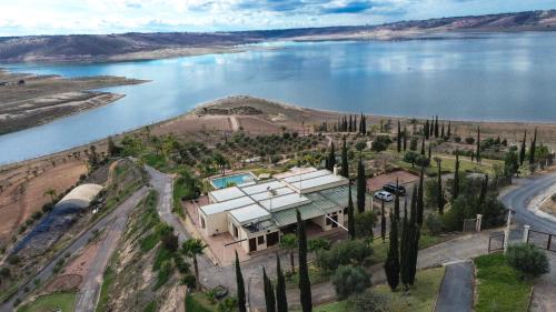 an aerial view of a house next to a lake at Lodge du Barrage in Rabat