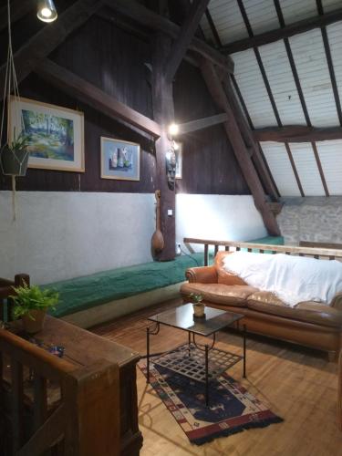 a living room with a couch and a table at Gîte Charlange in Pradelette