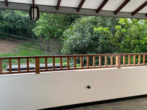 a view from the porch of a house with a wooden railing at SSK Rent Villas in Matara
