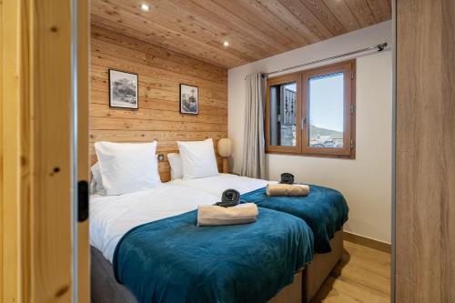 a bedroom with two beds with towels on them at Appartement Hermine in Les Allues