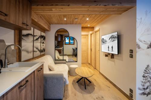 a kitchen and living room with a couch and a table at Appartement Hermine in Les Allues