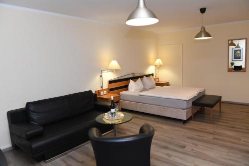 a hotel room with a bed and a couch at Herberge 39 in Meißen