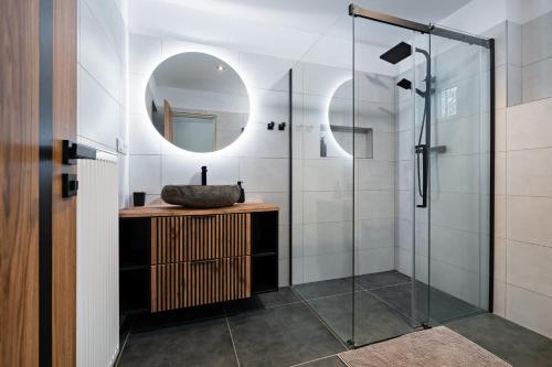 a bathroom with a sink and a mirror at Na Samotě u tratě in Nepomuk