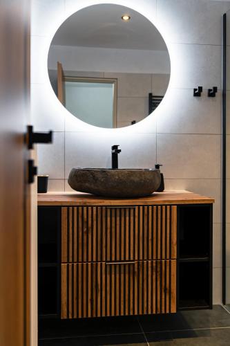 a bathroom with a sink and a mirror at Na Samotě u tratě in Nepomuk
