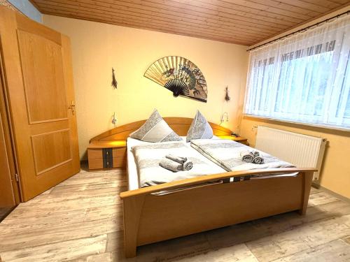 a bedroom with a bed and a window at Ferienwohnung Am Blessberg in Stelzen in Eisfeld