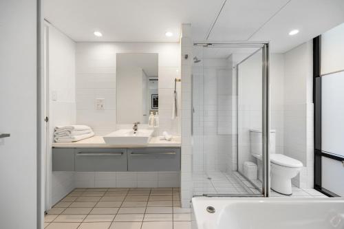 a bathroom with a shower and a sink and a toilet at Urban Oasis City 2 Bed Apartment Oaks Horizons in Adelaide
