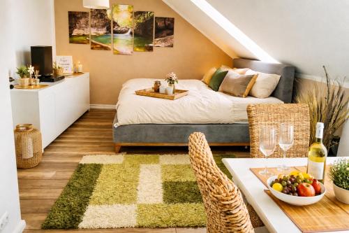a bedroom with a bed and a table with a bowl of fruit at Weidelandfarm am Riebener See in Beelitz