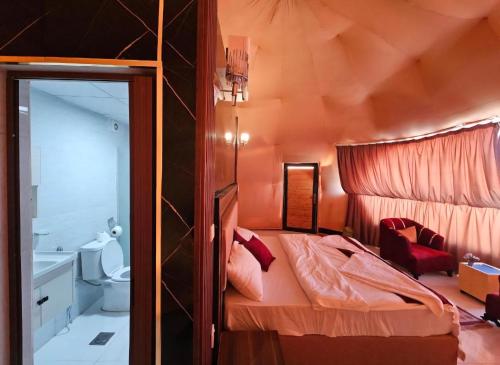 a small bedroom with a bed and a toilet at Joker camp Wadi Rum in Disah