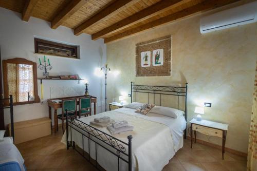 a bedroom with a large bed and two tables at Tri Re e 'na Regina in Cinisi