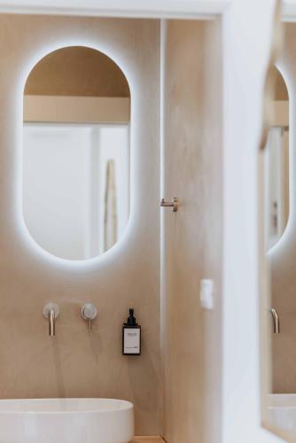 a bathroom with a sink and a mirror at Corte Vespro in Ugento