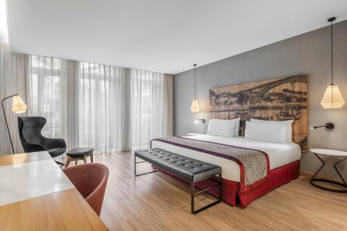a hotel room with a bed and a table at Eurostars Porto Centro in Porto