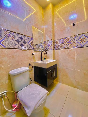 a bathroom with a toilet and a sink at Crown pyramids hotel in Cairo