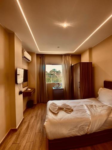 a hotel room with a bed and a window at Crown pyramids hotel in Cairo