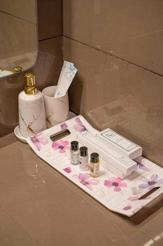 a white tray with pink flowers on a table at The Vilton in Raipur