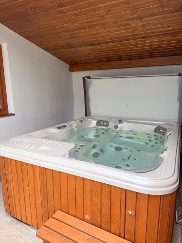 a large jacuzzi tub in a room at Sziget Vendégház Parád in Parád
