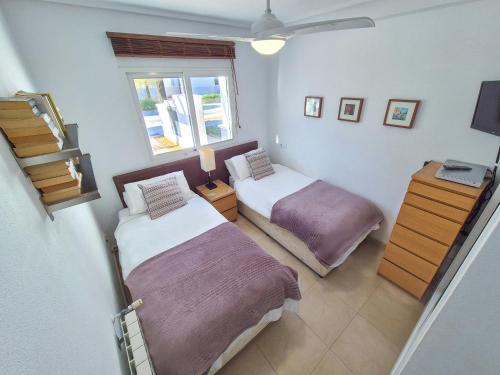a bedroom with two beds and a window at Casa La Torre in Roldán