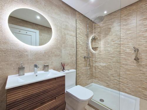 a bathroom with a sink and a toilet and a mirror at Casa La Torre in Roldán