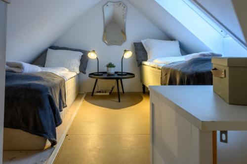 a attic room with two beds and a table at Best Stay Copenhagen Apartment 1470 in Copenhagen