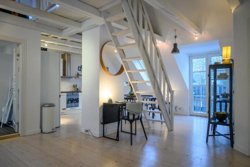 a living room with a staircase and a dining room at Best Stay Copenhagen Apartment 1470 in Copenhagen