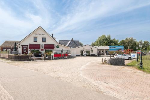 a building with a car parked in front of it at B&B De Betuwe Asch in Asch