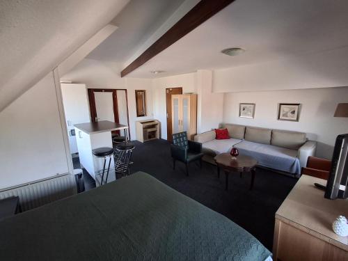 a living room with a couch and a table at B&B De Betuwe Asch in Asch