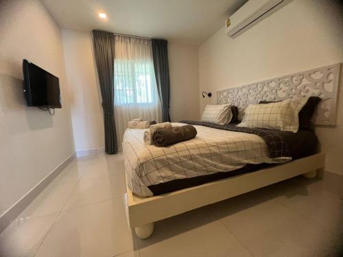 a bedroom with a bed and a television in it at The nice condo 2 BR at Karon in Karon Beach