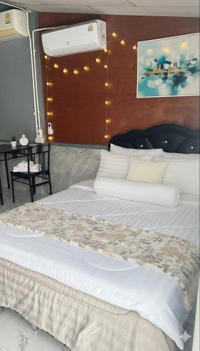 a bedroom with a large white bed with lights on it at Similan Resort & Water Fall in Ban Lam Ru (1)