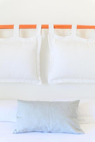 two white pillows sitting on top of a bed at Hotel Nobel in Gabicce Mare