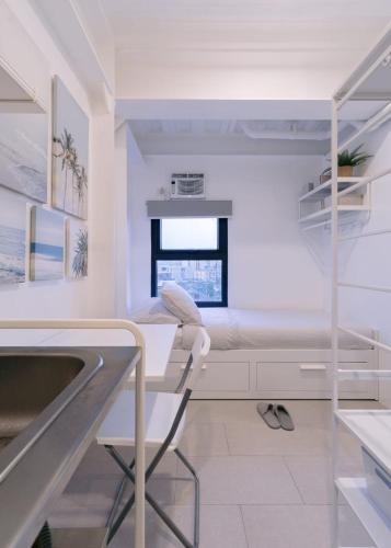 a hospital room with a bed and a sink at Canopy Agutaya BGC in Manila