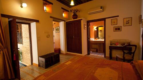 a living room with a wooden table and a bathroom at Ryad Salama in Fès