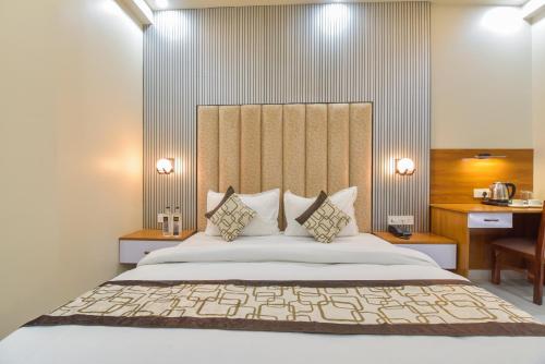 a bedroom with a large bed and a desk at INDRA PALACE Unit 2 in Jaipur